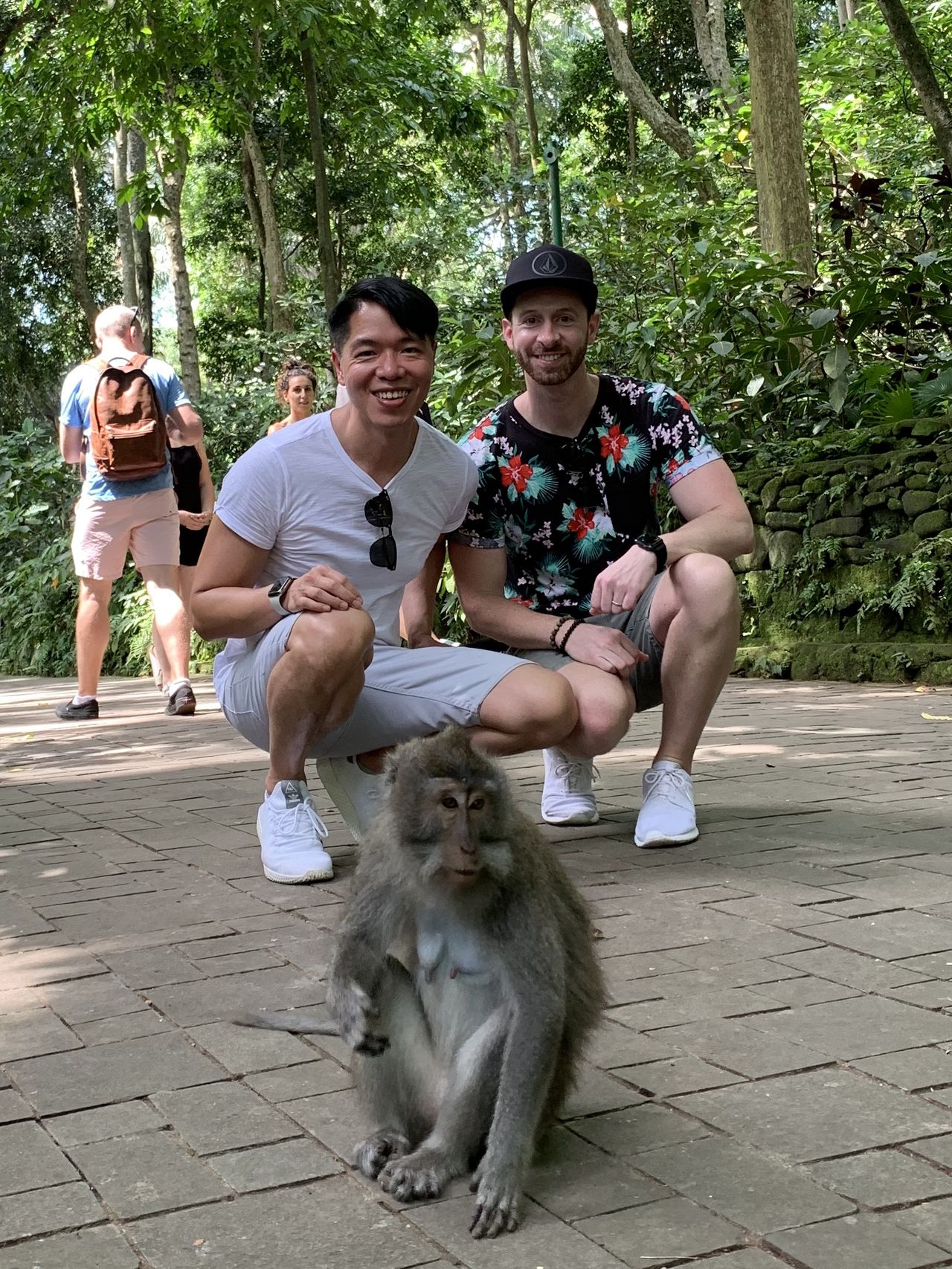 Benny and his partner with a macaque at the Ubud Monkey Forest in Bali