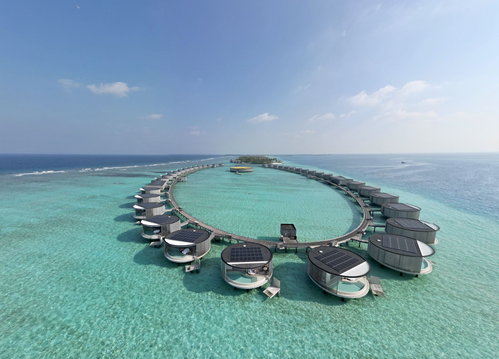Aerial view of the circular overwater villa ring at the Ritz-Carlton Maldives